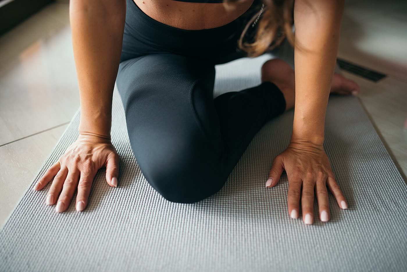 A person stretching on a yoga mat
