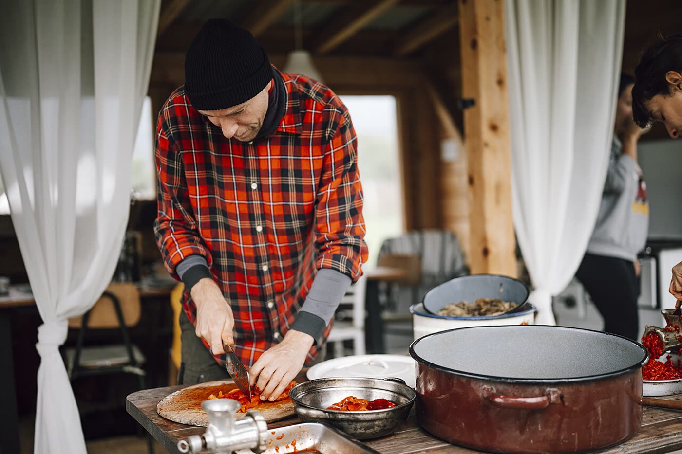 A person chopping fresh vegetables in a kitchen